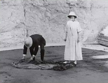 Professor Newberry and his wife unroll the linen pall (no. 206) from the shrine of King Tut.